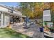 Exterior of house showing back patio with fireplace, seating, and lush landscaping at 4070 Whitewater Creek Nw Rd, Atlanta, GA 30327