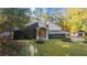 Beautiful front exterior of a home with a well-maintained lawn, mature trees and appealing architectural details at 4070 Whitewater Creek Nw Rd, Atlanta, GA 30327