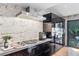 Contemporary kitchen featuring stainless appliances, gas range, and sleek black cabinetry at 4070 Whitewater Creek Nw Rd, Atlanta, GA 30327