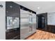 Modern kitchen features stainless steel refrigerator and black cabinets at 4070 Whitewater Creek Nw Rd, Atlanta, GA 30327