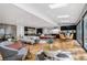 Open-concept living room with modern furnishings flows seamlessly into a gourmet kitchen and dining area with hardwood floors at 4070 Whitewater Creek Nw Rd, Atlanta, GA 30327