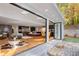 Open-concept living room with hardwood floors, modern kitchen, and glass doors to the outdoors at 4070 Whitewater Creek Nw Rd, Atlanta, GA 30327