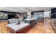Open-concept living room with modern kitchen, island, and backyard access at 4070 Whitewater Creek Nw Rd, Atlanta, GA 30327