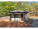 Charming outbuilding featuring board and batten siding, brick foundation, and a well manicured yard at 4070 Whitewater Creek Nw Rd, Atlanta, GA 30327