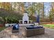 Inviting patio with cozy outdoor fireplace, comfortable seating, and scenic backyard views for entertaining at 4070 Whitewater Creek Nw Rd, Atlanta, GA 30327
