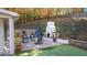 Outdoor patio with white brick fireplace, comfortable seating, and beautiful landscaping, perfect for entertaining at 4070 Whitewater Creek Nw Rd, Atlanta, GA 30327