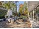 Inviting patio with a brick fireplace, comfortable seating, and lush greenery, ideal for outdoor relaxation and entertaining at 4070 Whitewater Creek Nw Rd, Atlanta, GA 30327