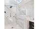 Walk-in shower with elegant marble walls, bench seating, and modern fixtures for a spa-like experience at 4070 Whitewater Creek Nw Rd, Atlanta, GA 30327