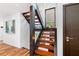 Contemporary staircase with wood treads, sleek railing, and stylish design elements at 4070 Whitewater Creek Nw Rd, Atlanta, GA 30327