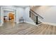 Basement rec area features access to another room and an ornate staircase with black iron railings at 5021 Heatherwood Ct, Roswell, GA 30075