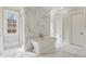 Beautiful bathroom with free-standing tub, walk-in shower, and elegant marble accents at 5021 Heatherwood Ct, Roswell, GA 30075