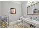 Powder bath featuring a classic sink, beautiful travertine floors, and decorative accents at 5021 Heatherwood Ct, Roswell, GA 30075