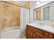 Bathroom with a wood vanity, white countertop, and a shower/tub combination behind a white curtain at 5021 Heatherwood Ct, Roswell, GA 30075