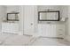 Bright bathroom with double vanities and white marble flooring at 5021 Heatherwood Ct, Roswell, GA 30075