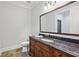 Bathroom features a wood vanity with dark marble countertop and a large framed mirror at 5021 Heatherwood Ct, Roswell, GA 30075