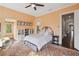 Comfortable bedroom with a colorful rug, bed, bookcase, and a sunny window seating area at 5021 Heatherwood Ct, Roswell, GA 30075