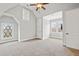 Bedroom with white walls and carpeting, a ceiling fan, and two windows for natural light at 5021 Heatherwood Ct, Roswell, GA 30075