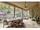 Covered patio with an outdoor dining set and ceiling fan, offering a comfortable space for entertaining and relaxation at 5021 Heatherwood Ct, Roswell, GA 30075