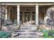 Covered back patio with brick columns and steps leading to the backyard, perfect for outdoor gatherings at 5021 Heatherwood Ct, Roswell, GA 30075