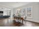 Dining room featuring large windows, hardwood floors, and access to the living area for easy entertaining at 5021 Heatherwood Ct, Roswell, GA 30075