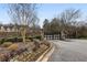 Gated community entrance with stone pillars, landscaping, and a secure entry system offers exclusivity and peace of mind at 5021 Heatherwood Ct, Roswell, GA 30075