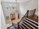 Grand two-story foyer boasting a beautiful chandelier, arched doorway, staircase, and elegant tile flooring at 5021 Heatherwood Ct, Roswell, GA 30075