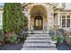 Charming front porch with stone archway and brick steps, a welcoming entryway with elegant details and mature landscaping at 5021 Heatherwood Ct, Roswell, GA 30075