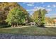 Beautifully landscaped front yard with mature trees and a horse statue, adding to the home's curb appeal at 5021 Heatherwood Ct, Roswell, GA 30075
