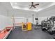 Home gym equipped with various exercise machines and weights with padded flooring at 5021 Heatherwood Ct, Roswell, GA 30075