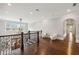 Spacious hallway featuring hardwood floors, ornate railing, recessed lighting, and a view of the foyer at 5021 Heatherwood Ct, Roswell, GA 30075
