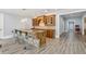 Basement bar with stone accents, wooden cabinetry, pendant lighting, and seating for four at 5021 Heatherwood Ct, Roswell, GA 30075