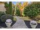 Professionally landscaped yard with brick walkway and lush plantings, enhancing the outdoor experience with thoughtful design at 5021 Heatherwood Ct, Roswell, GA 30075