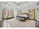 Serene main bedroom with large windows, coffered ceilings, and luxurious furnishings at 5021 Heatherwood Ct, Roswell, GA 30075