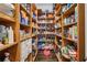 Spacious walk-in pantry with custom shelving providing ample storage for food and household items at 5021 Heatherwood Ct, Roswell, GA 30075