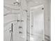Modern shower with multiple shower heads and marble tile at 5021 Heatherwood Ct, Roswell, GA 30075