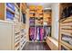 Custom walk-in closet featuring dark wood floors, built-in shelves and drawers, hanging rods, and plenty of storage space at 5021 Heatherwood Ct, Roswell, GA 30075