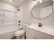 Updated bathroom with white vanity, oval mirror, and shower/tub combo at 1565 Ocala Sw Ave, Atlanta, GA 30311