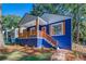 Blue house with white trim, orange door and wood details at 1565 Ocala Sw Ave, Atlanta, GA 30311