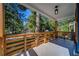 Inviting front porch with wood railing and light fixture at 1565 Ocala Sw Ave, Atlanta, GA 30311