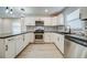 Modern white kitchen with stainless steel appliances and dark countertops at 1565 Ocala Sw Ave, Atlanta, GA 30311