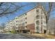 Low angle shows condo exterior with multiple balconies and covered parking beneath the building at 4333 Dunwoody Park Dr # 3406, Dunwoody, GA 30338