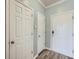 Hallway featuring three interior doors and plank flooring at 4333 Dunwoody Park Dr # 3406, Dunwoody, GA 30338