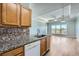 Kitchen area features stainless steel appliances, stone countertops, and backsplash overlooking living area at 4333 Dunwoody Park Dr # 3406, Dunwoody, GA 30338