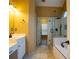 Bright bathroom featuring double vanity sinks, framed mirror, and a large walk-in shower and garden tub combo at 100 Cottonwood Pl, Stockbridge, GA 30281