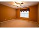 Bedroom has a ceiling fan and large window at 100 Cottonwood Pl, Stockbridge, GA 30281