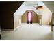 Spacious bedroom with vaulted ceiling, dormer window, carpet, and neutral walls at 100 Cottonwood Pl, Stockbridge, GA 30281