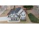 Aerial view of home with manicured lawn, dark roof, and fenced backyard at 100 Cottonwood Pl, Stockbridge, GA 30281