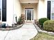 Inviting front entrance with decorative plants and walkway at 100 Cottonwood Pl, Stockbridge, GA 30281