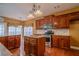 Traditional-style kitchen with cherry cabinets, granite counters, stainless appliances, tile backsplash and an island with seating at 100 Cottonwood Pl, Stockbridge, GA 30281