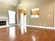 Spacious living room with hardwood floors, fireplace, and view into the sunny kitchen at 100 Cottonwood Pl, Stockbridge, GA 30281